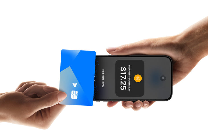 Customer taps a contactless card on a merchant's iPhone using Tap to Pay on iPhone in a retail store