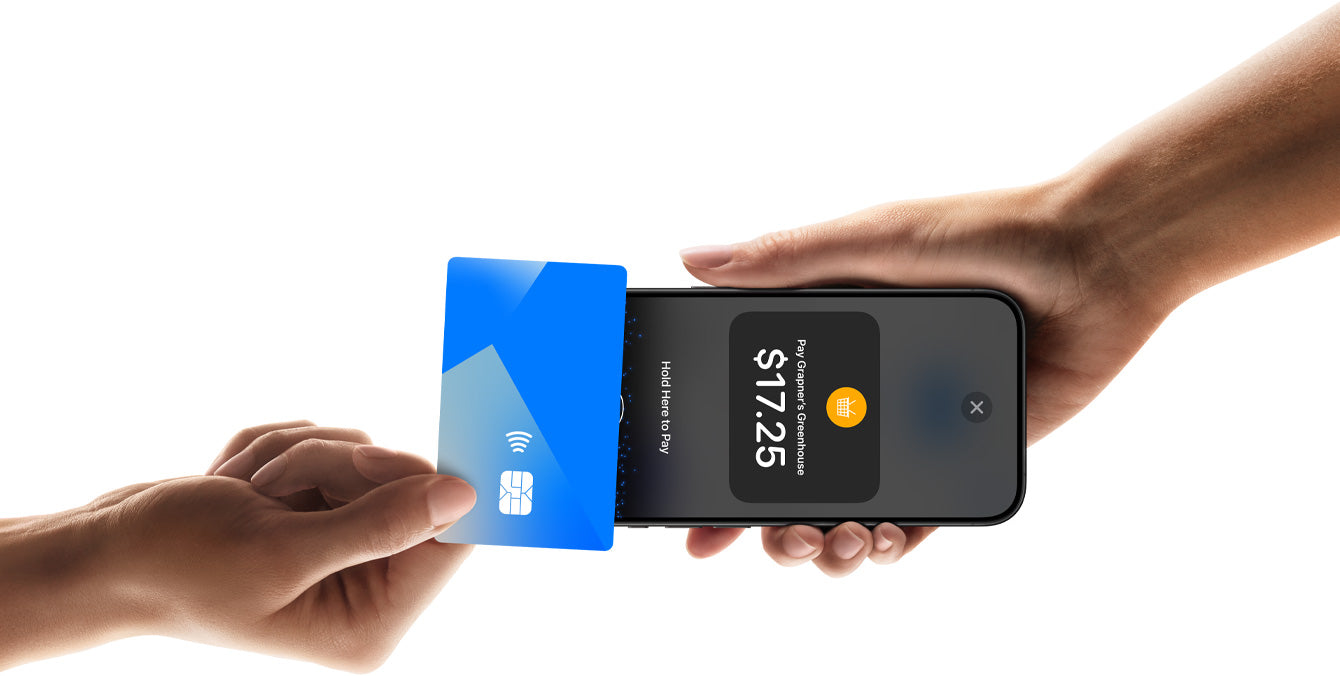 Customer taps a contactless card on a merchant's iPhone using Tap to Pay on iPhone in a retail store